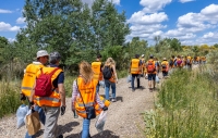 A group of Repsol volunteers walks through a field at a volunteer event